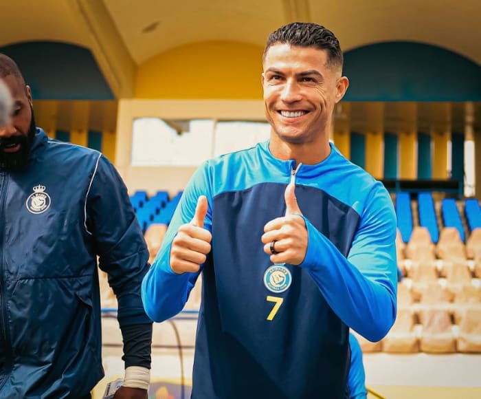 Cristiano Ronaldo pictured giving a double thumbs up gesture to the camera while posing for a photograph during an Al Nassr training session on his 39th birthday in February 2024